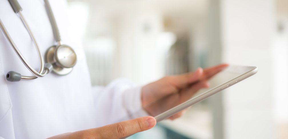 Doctor using tablet computer