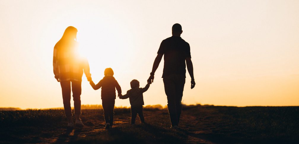 Happy family silhouette on the sunset